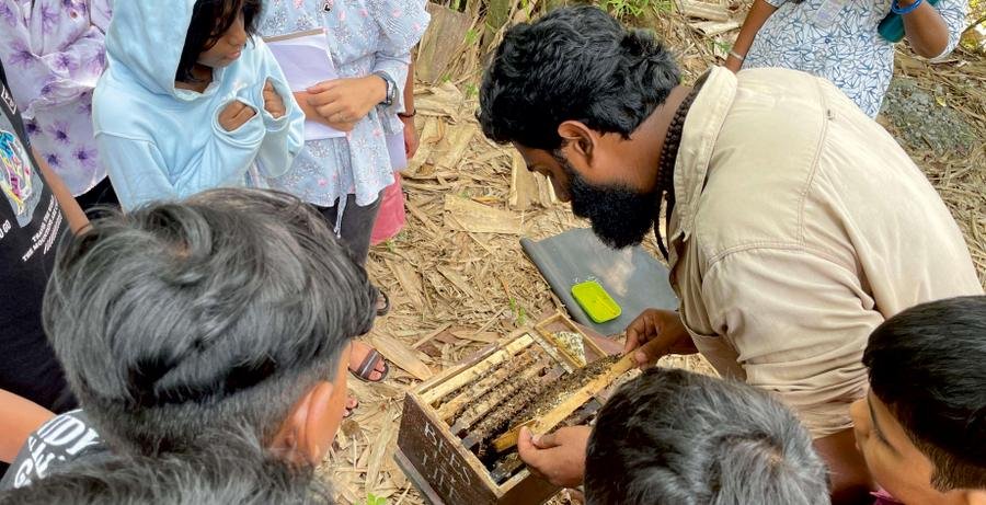 A research scholar shows students a specimen