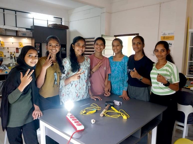 Students with LED bulbs they built